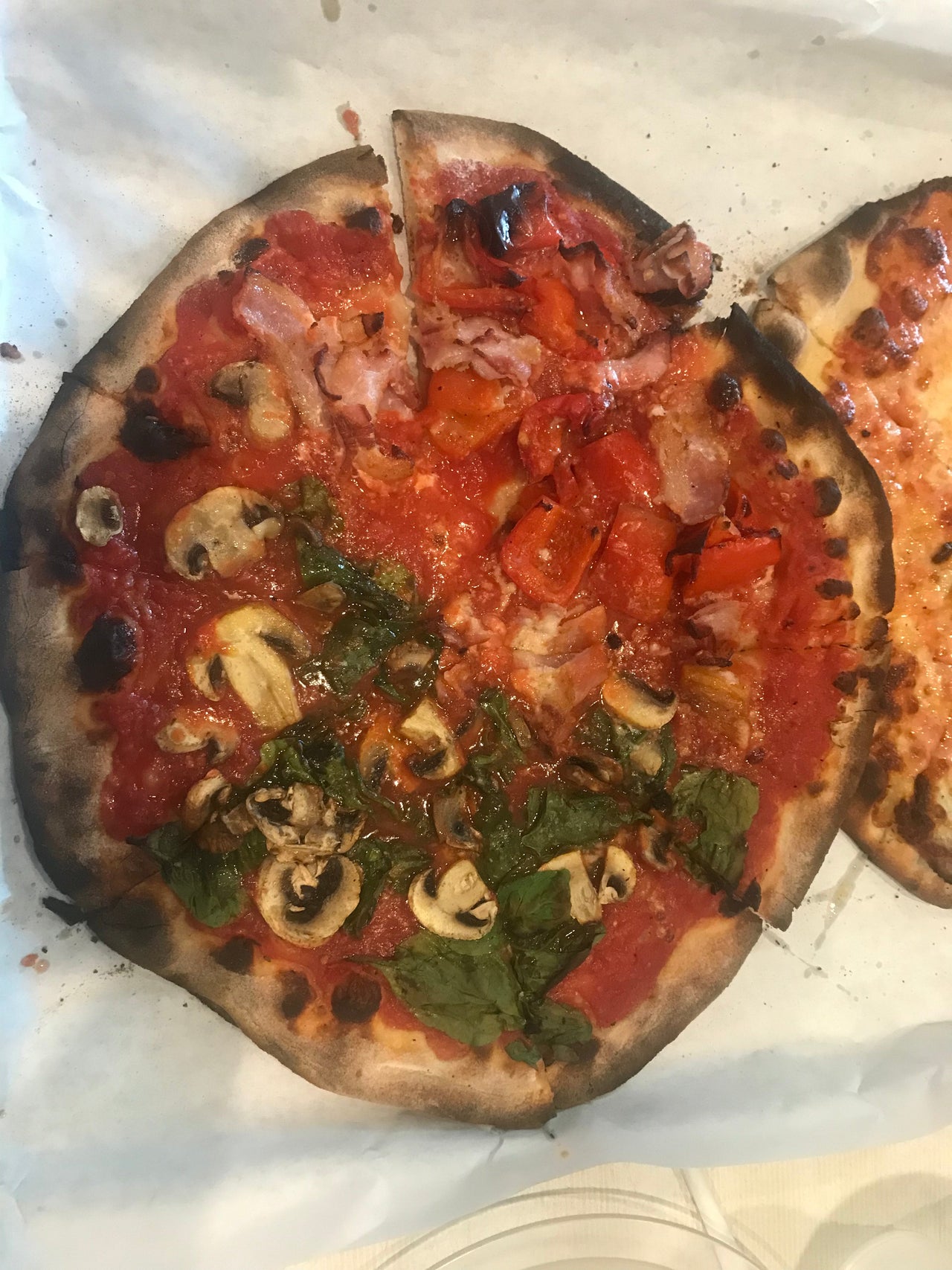 Frank Pepe Pizzeria serves miracle pizzas from bacon roasted red pepper to white clam with charred crust and bubbling mozzarella at the iconic Wooster Street location in New Haven, CT.