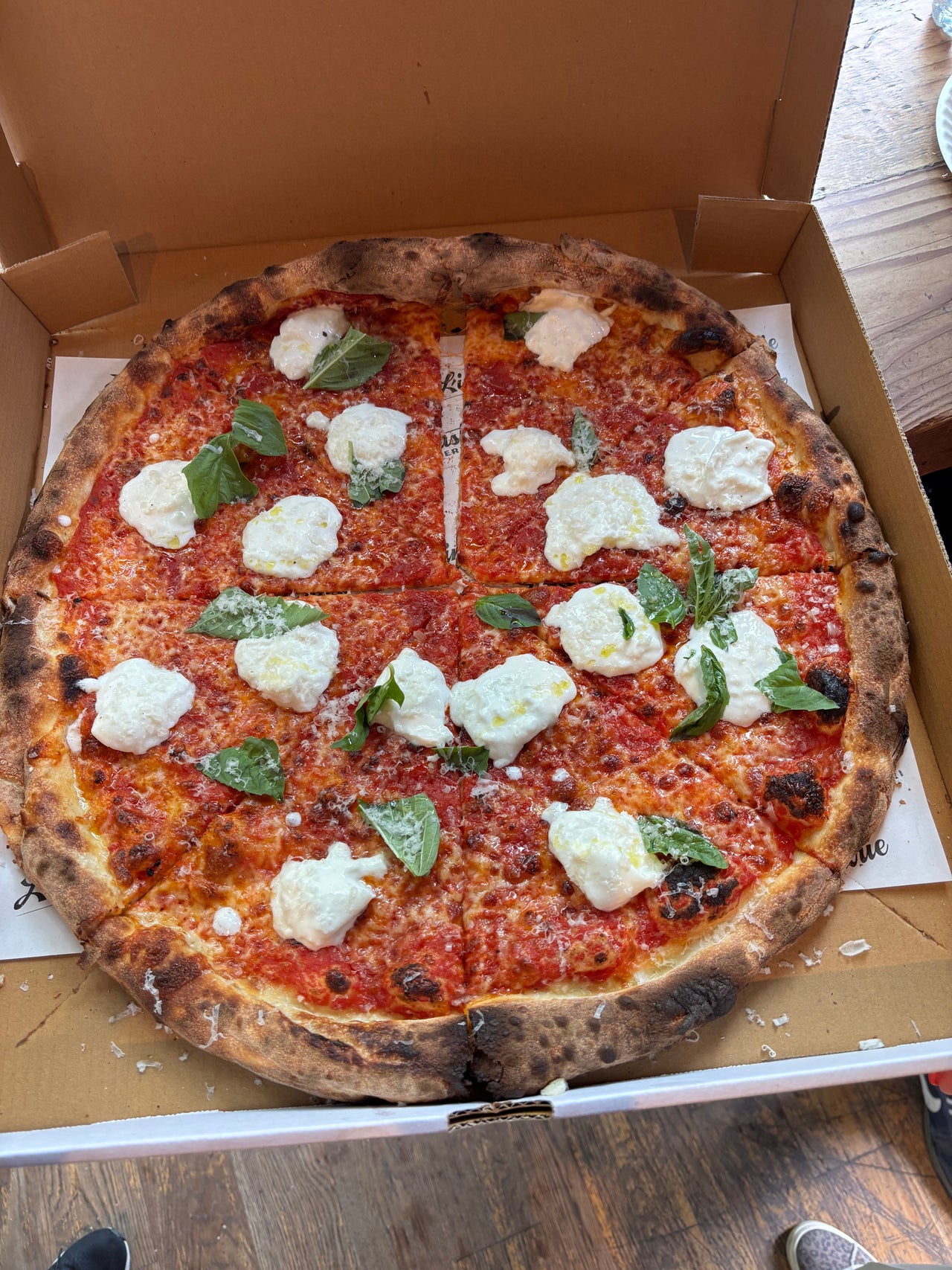 L’Industrie Pizzeria Burrata Pie in Brooklyn with tomato sauce, mozzarella and creamy burrata served fresh in its pizza box.
