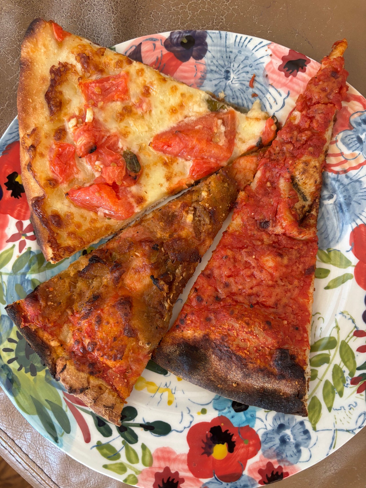 A slice of Fresh Tomato pizza from Frank Pepe Pizzeria Napoletana in New Haven, Connecticut, featuring sweet seasonal tomatoes, fresh mozzarella, garlic, olive oil, and a charred coal-fired crust.