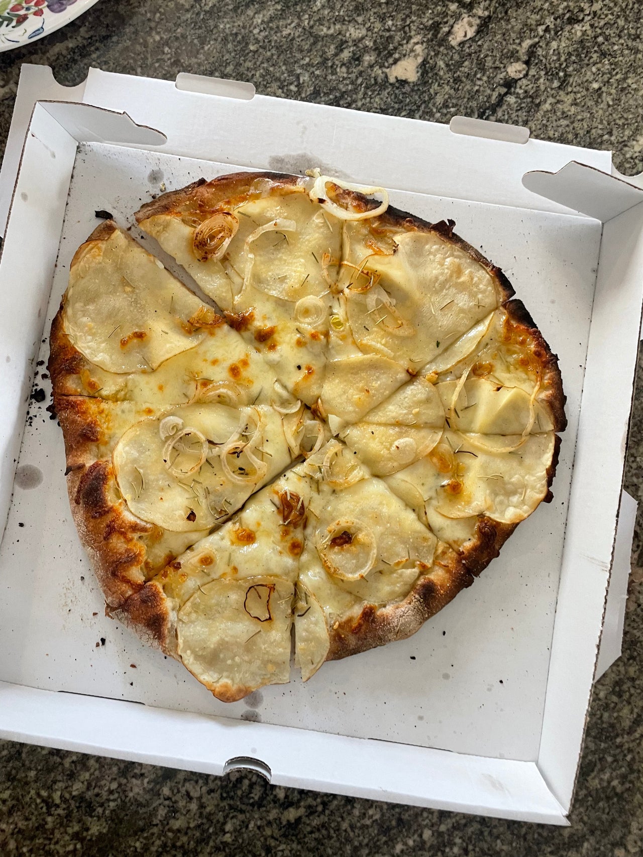 Coal-fired potato & rosemary pizza with charred crust from Sally's Apizza